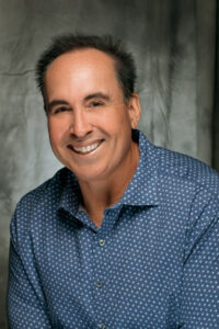 a professional photo of John Garcia, a local real estate expert in Huntington Beach, CA